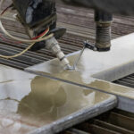 5-axis waterjet bevel cutting examples, including tapered and angled edges, precision holes, and clean cuts on metal parts.